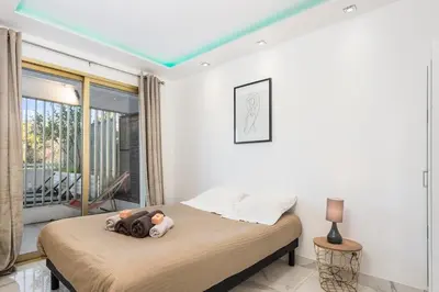 a bedroom with a bed with a teddy bear on it at Mimosas Lovers in Cannes