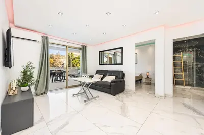 a living room with a couch and a table at Mimosas Lovers in Cannes