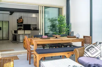 a dining room with a wooden table and chairs at Magnifique villa avec piscine in Le Cannet