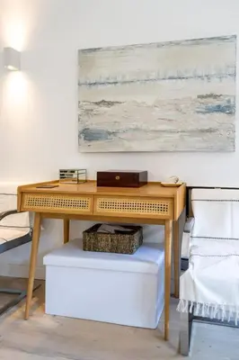 a wooden desk with a laptop on it next to two chairs at Magnifique villa avec piscine in Le Cannet