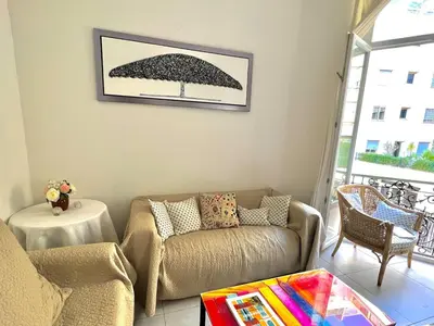 a living room with a couch and a table at Panter Properties-24 in Cannes