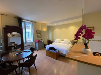 a hotel room with a bed and a table and a tableablish at Panter Properies Studio in Cannes