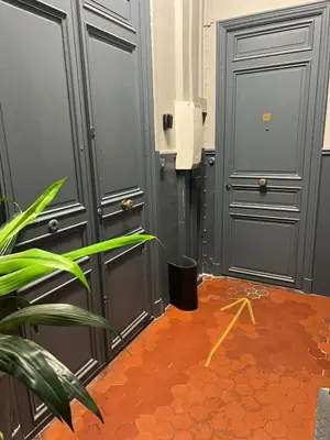 a hallway with two grey doors and a orange floor at Panter Properies Studio in Cannes