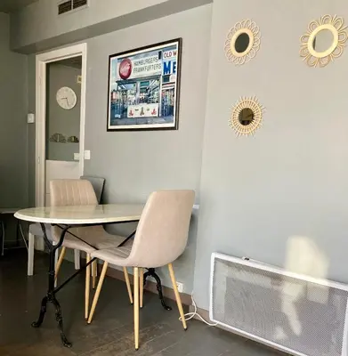 a dining room with a table and chairs and a tv at Cannes South of France Apartment near beach, Palais des Festivals and Croisette in Cannes