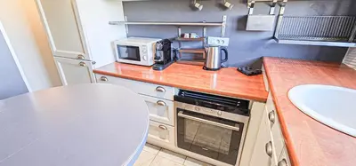 a kitchen with a counter with a microwave and a sink at Cannes South of France Apartment near beach, Palais des Festivals and Croisette in Cannes