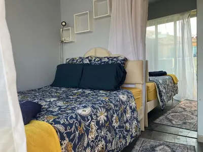 a small bedroom with a bed and a window at Cannes South of France Apartment near beach, Palais des Festivals and Croisette in Cannes