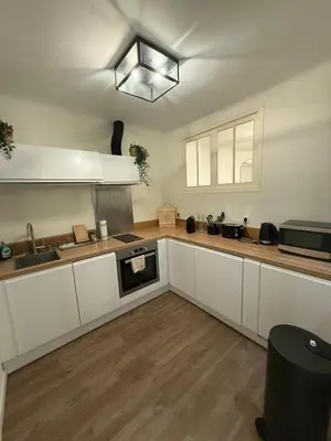 a kitchen with white cabinets and a sink and a microwave at COZY apartment 5 min Croisette Palais Festivals in Cannes