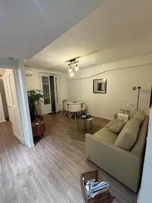 a living room with a couch and a table at COZY apartment 5 min Croisette Palais Festivals in Cannes