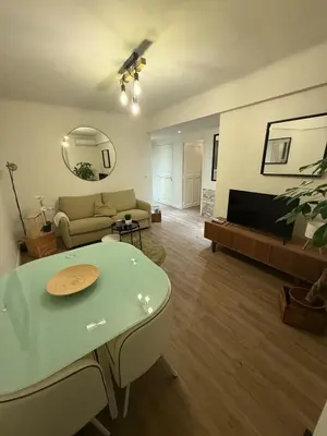 a living room with a couch and a table at COZY apartment 5 min Croisette Palais Festivals in Cannes