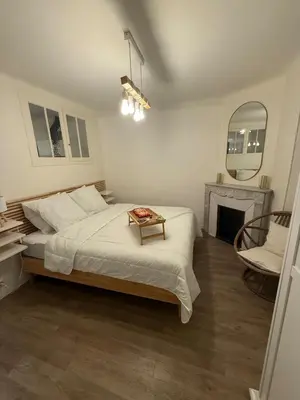 a bedroom with a bed and a mirror and a chair at COZY apartment 5 min Croisette Palais Festivals in Cannes