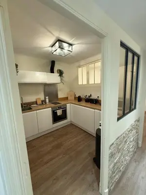 a kitchen with white cabinets and a counter top at COZY apartment 5 min Croisette Palais Festivals in Cannes