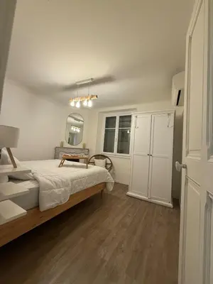 a bedroom with a bed and a table in it at COZY apartment 5 min Croisette Palais Festivals in Cannes