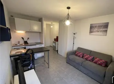 a living room with a couch and a table at Studio Cannes in Le Cannet