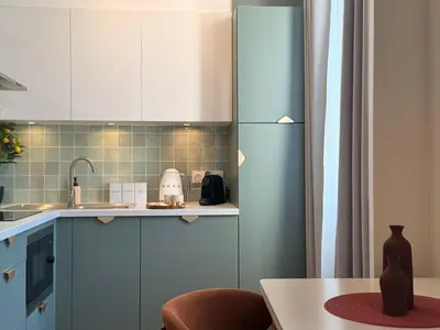 a bed with a pillow with a palm tree on it at Suite Tosca - Palais & Croisette 2min - Appartement Hôtel in Cannes