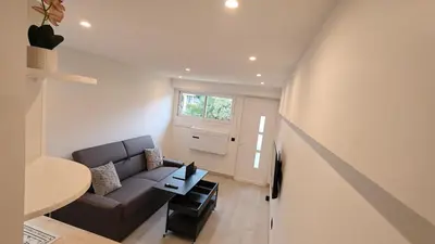 a living room with a couch and a table at Studio moderne in Cannes