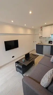 a living room with a couch and a flat screen tv at Studio moderne in Cannes