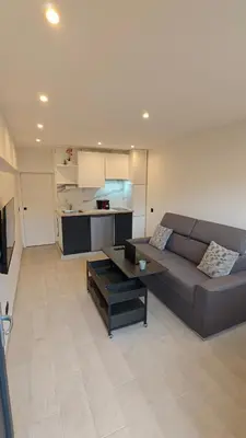 a living room with a couch and a table at Studio moderne in Cannes