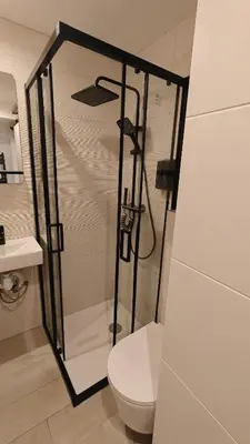 a bathroom with a shower with a toilet and a sink at Studio moderne in Cannes