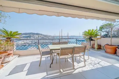 a patio with a table and chairs on a balcony at REF 774 - Cannes Old Port - Sea view partment for rent in Cannes