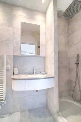 a bathroom with a sink and a mirror and a tub at REF 774 - Cannes Old Port - Sea view partment for rent in Cannes