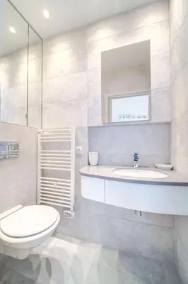 a bathroom with a toilet and a sink and a mirror at REF 774 - Cannes Old Port - Sea view partment for rent in Cannes