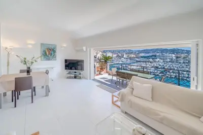a living room with a couch and a table at REF 774 - Cannes Old Port - Sea view partment for rent in Cannes
