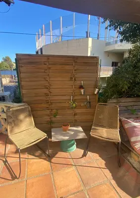 two chairs and a table on a patio at Joli appartement avec jardin in Cannes