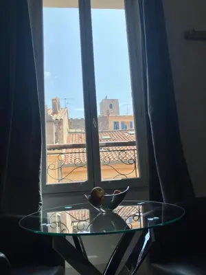 a glass table in front of a window with a view at Studio à Cannes quartier du Suquet in Cannes