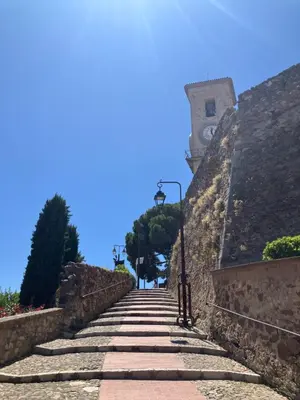 a stone path leading up to a building with a clock tower at Studio à Cannes quartier du Suquet in Cannes