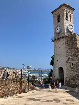 a clock tower with people walking around in front of it at Studio à Cannes quartier du Suquet in Cannes