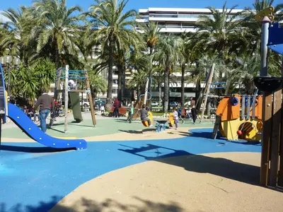 a playground with children playing on slides and swings at PALME Yacht - Cannes Port Canto - Pointe Croisette - Face à la Mer in Cannes