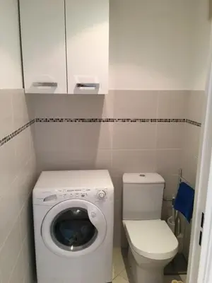 a small bathroom with a toilet and a washing machine at Le Carre Montfleury Cannes in Cannes