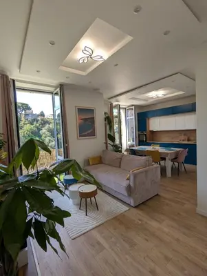 a living room with a couch and a table at Central Cannes Cozy T4 Walk to Beach & Congress in Cannes