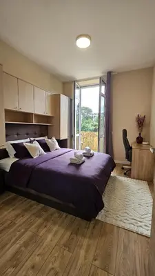 a bedroom with a large bed and a large window at Central Cannes Cozy T4 Walk to Beach & Congress in Cannes