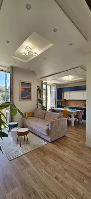 a living room with a couch and a table at Central Cannes Cozy T4 Walk to Beach & Congress in Cannes