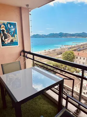 a balcony with a table and a view of the beach at Apartment Cannes sea view! in Cannes
