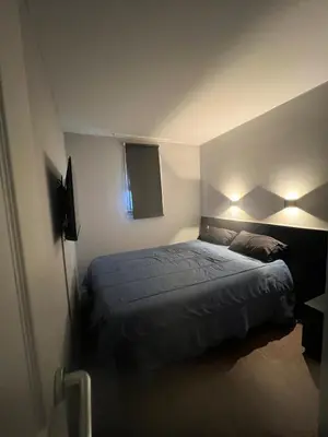 a bedroom with a bed and lights on the wall at Apartment Cannes sea view! in Cannes