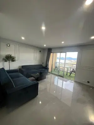 a living room with a couch and a large window at Apartment Cannes sea view! in Cannes