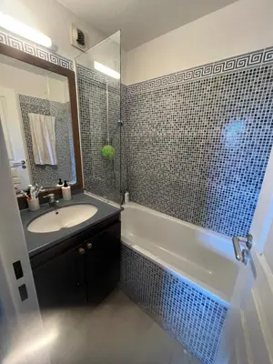 a bathroom with a tub and a sink and a mirror at Apartment Cannes sea view! in Cannes