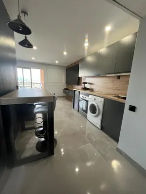 a kitchen with a table and a washing machine at Apartment Cannes sea view! in Cannes