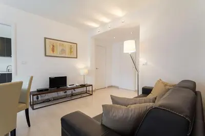 a living room with a couch and a television at Charming & Elegant La Croisette apartment in Cannes in Cannes