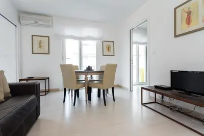 a living room with a table and chairs and a couch at Charming & Elegant La Croisette apartment in Cannes in Cannes
