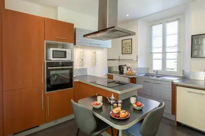 a kitchen with a table with fruit on it at C10 - 3P 10 min Palais Festivals & Sea - AC & Parking in Cannes
