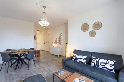a living room with a couch and a table at C10 - 3P 10 min Palais Festivals & Sea - AC & Parking in Cannes