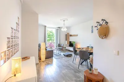 a living room with a table and a dining room at C10 - 3P 10 min Palais Festivals & Sea - AC & Parking in Cannes