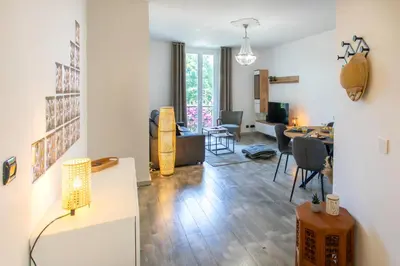 a living room with a table and chairs and a living room at C10 - 3P 10 min Palais Festivals & Sea - AC & Parking in Cannes