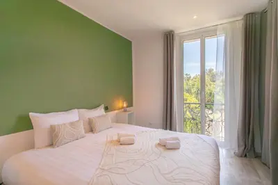 a bedroom with a large white bed with a window at C10 - 3P 10 min Palais Festivals & Sea - AC & Parking in Cannes