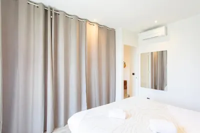 a bedroom with a bed and a window with curtains at C10 - 3P 10 min Palais Festivals & Sea - AC & Parking in Cannes