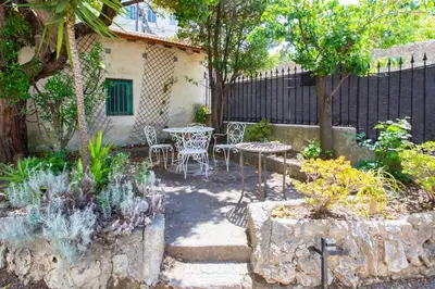 a patio with a table and chairs in a garden at C10 - 3P 10 min Palais Festivals & Sea - AC & Parking in Cannes
