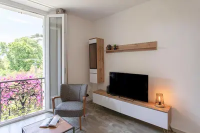 a living room with a tv and a window at C10 - 3P 10 min Palais Festivals & Sea - AC & Parking in Cannes